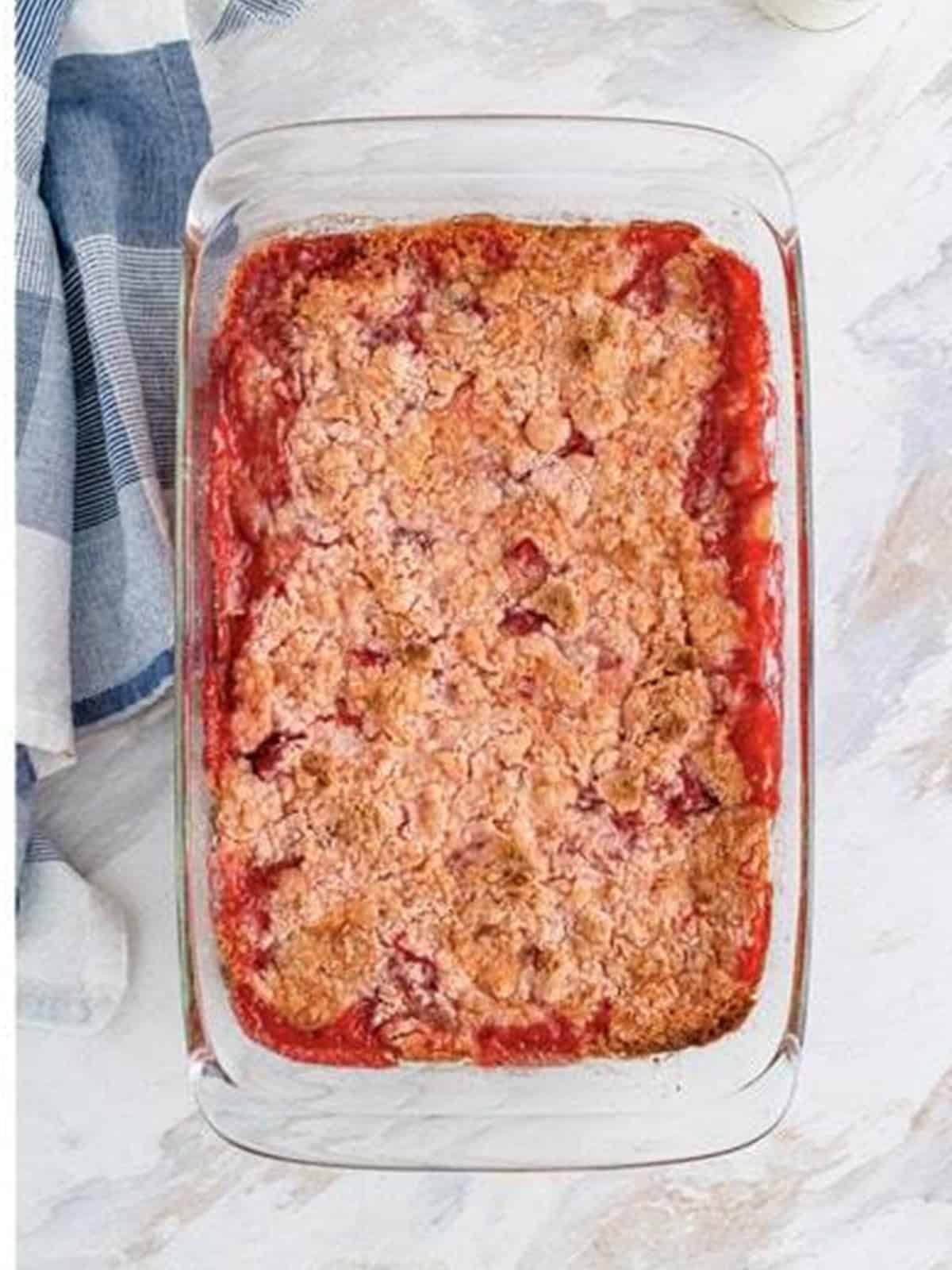 Baked Strawberry Dump Cake golden and bubbling in the baking dish.
