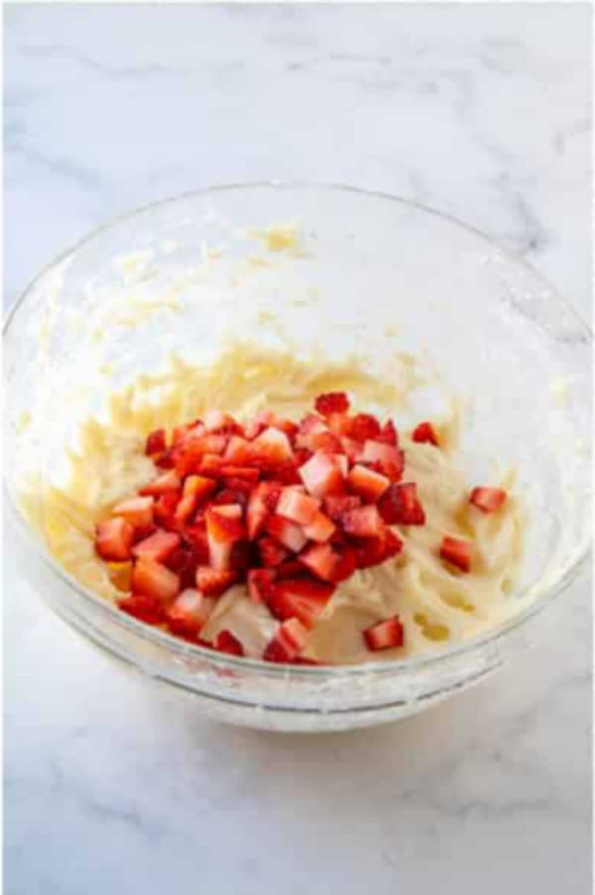Fresh strawberries folded into the cheesecake mixture.