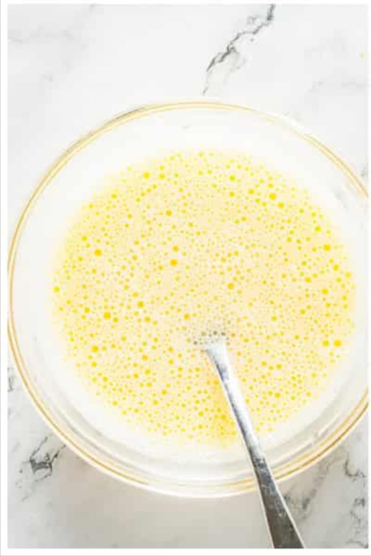 Wet and dry ingredients mixed into a smooth batter for sweet and sour chicken.