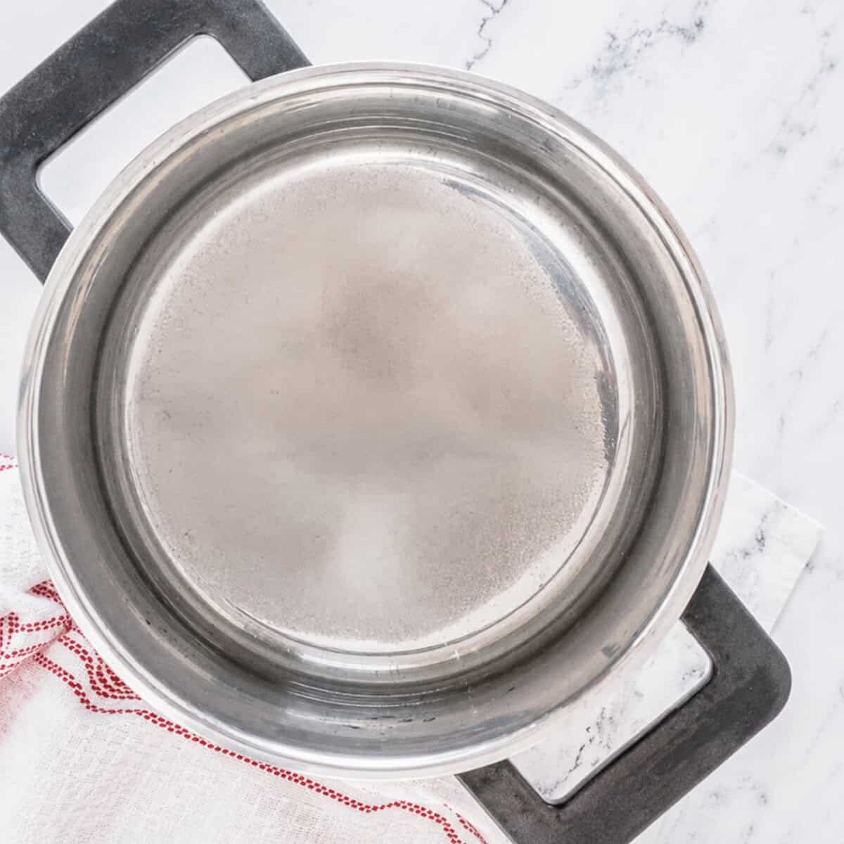 Empty stainless saucepan ready for Sweet and Sour Sauce ingredients.