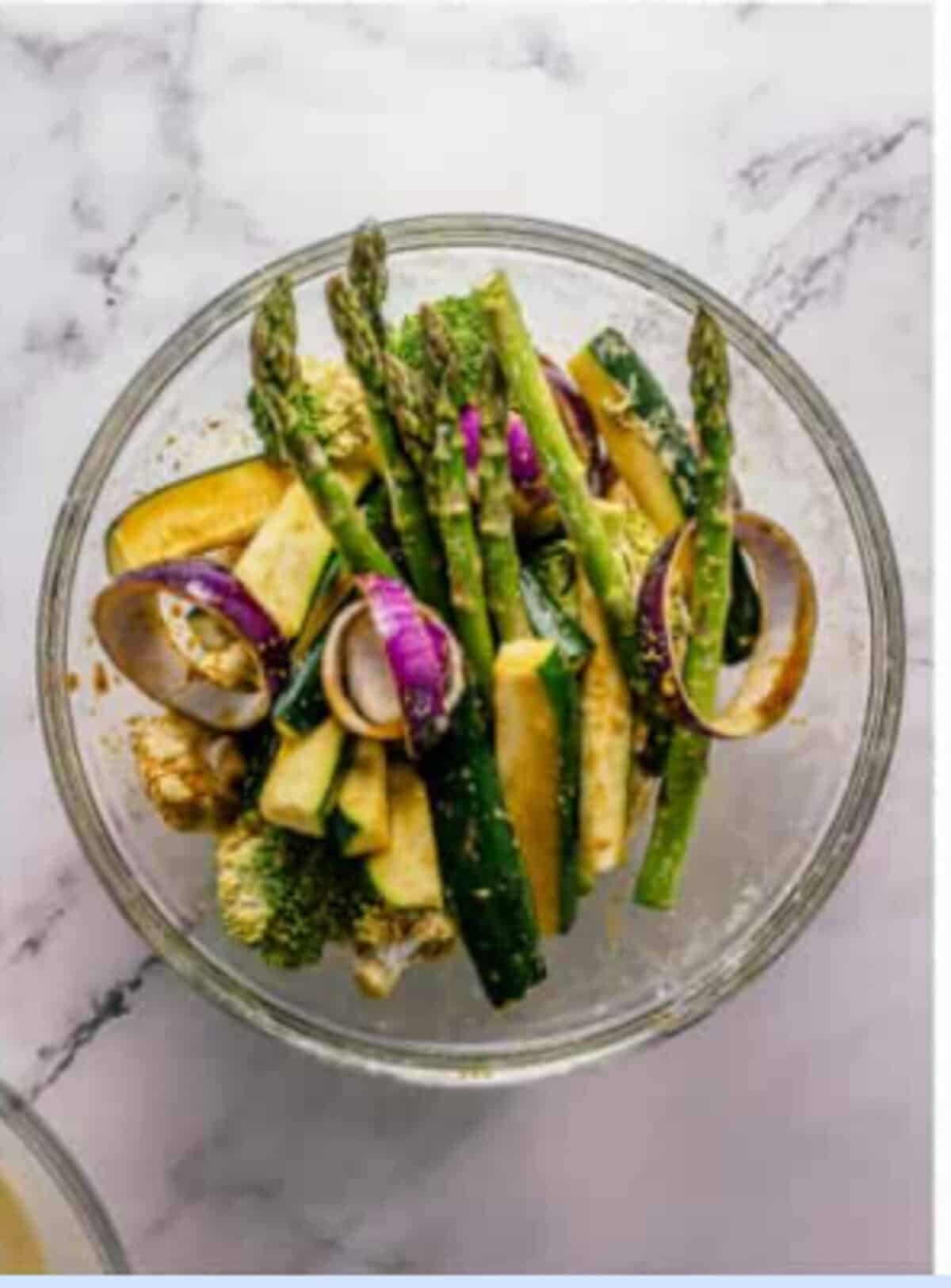 Assorted vegetables sliced into 1/4-inch sticks and pieces in a large bowl ready to be marinated for the Crispy Tempura Vegetables Recipe.