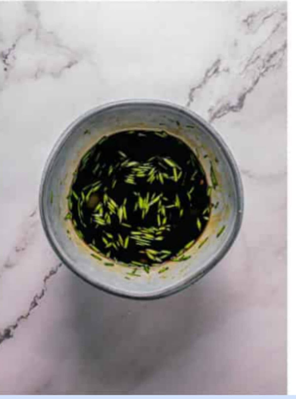 Soy-based dipping sauce being stirred in a small saucepan with rice wine vinegar, chili paste, and thinly sliced scallions for the Crispy Tempura Vegetables Recipe.