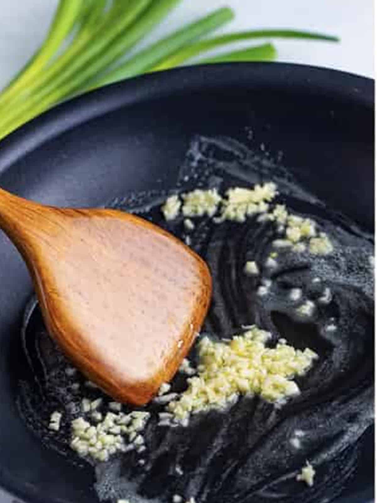 Melting butter in a black skillet to start TikTok ramen noodles.