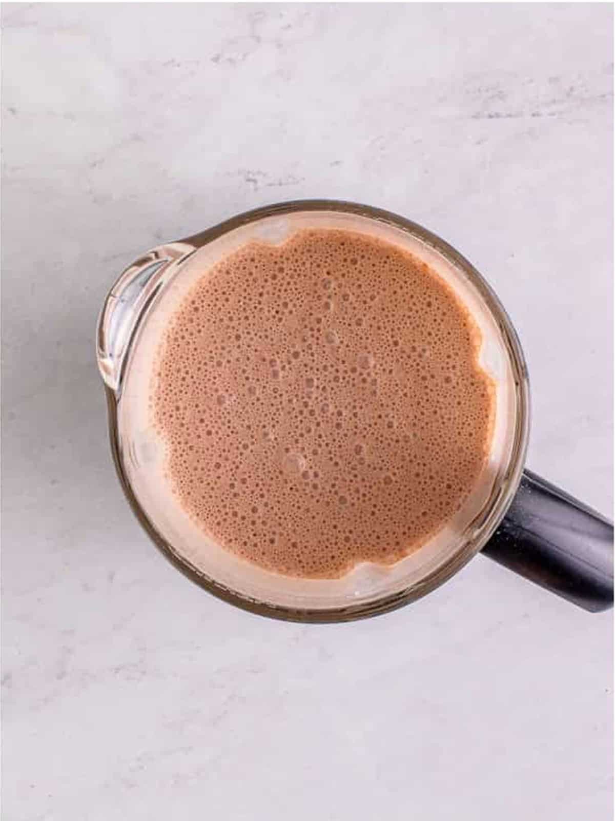 Blended smooth chocolate Wendys Frosty mixture in a blender.