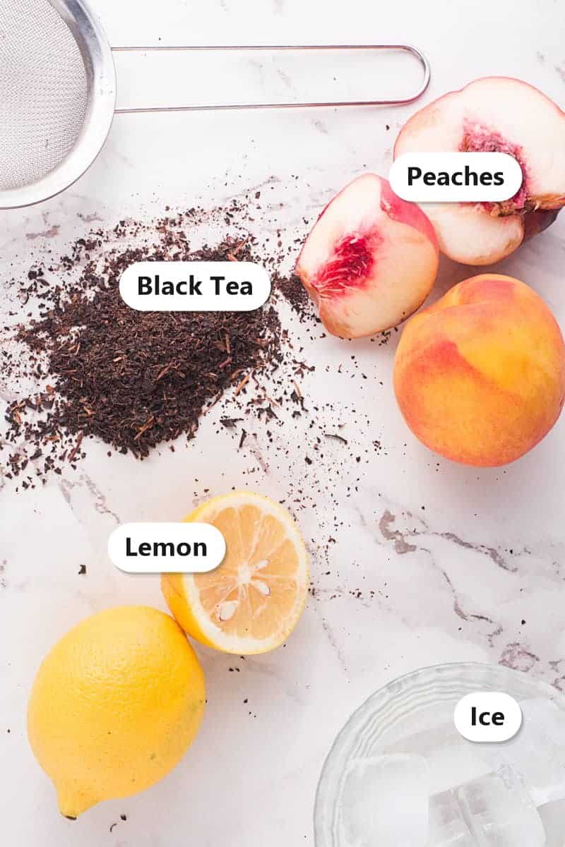 Ingredients to make a Peach Arnold Palmer labeled including black tea, peaches, lemon, and ice.