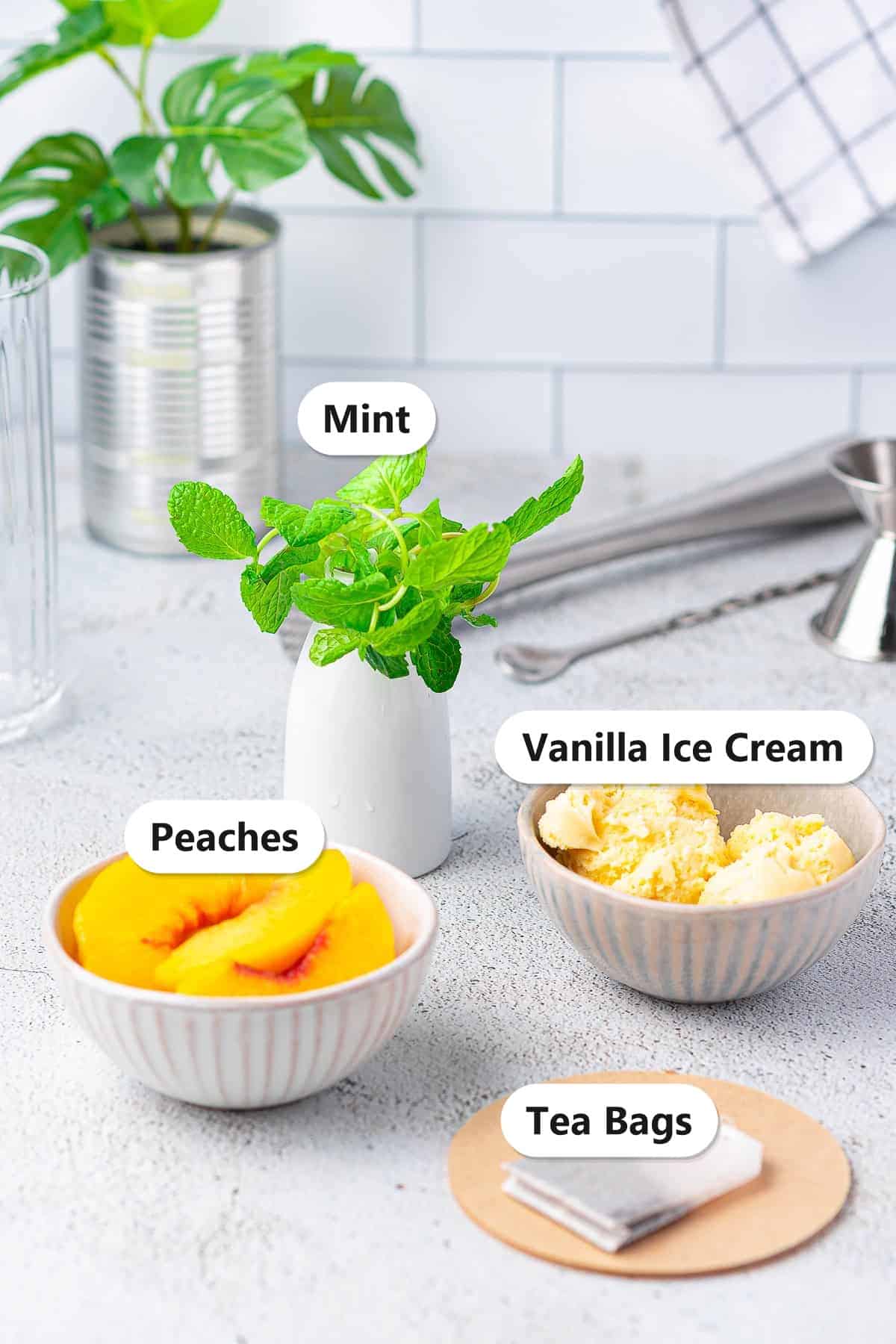 Labeled ingredients for peach tea including fresh peaches, mint, vanilla ice cream, and black tea bags.
