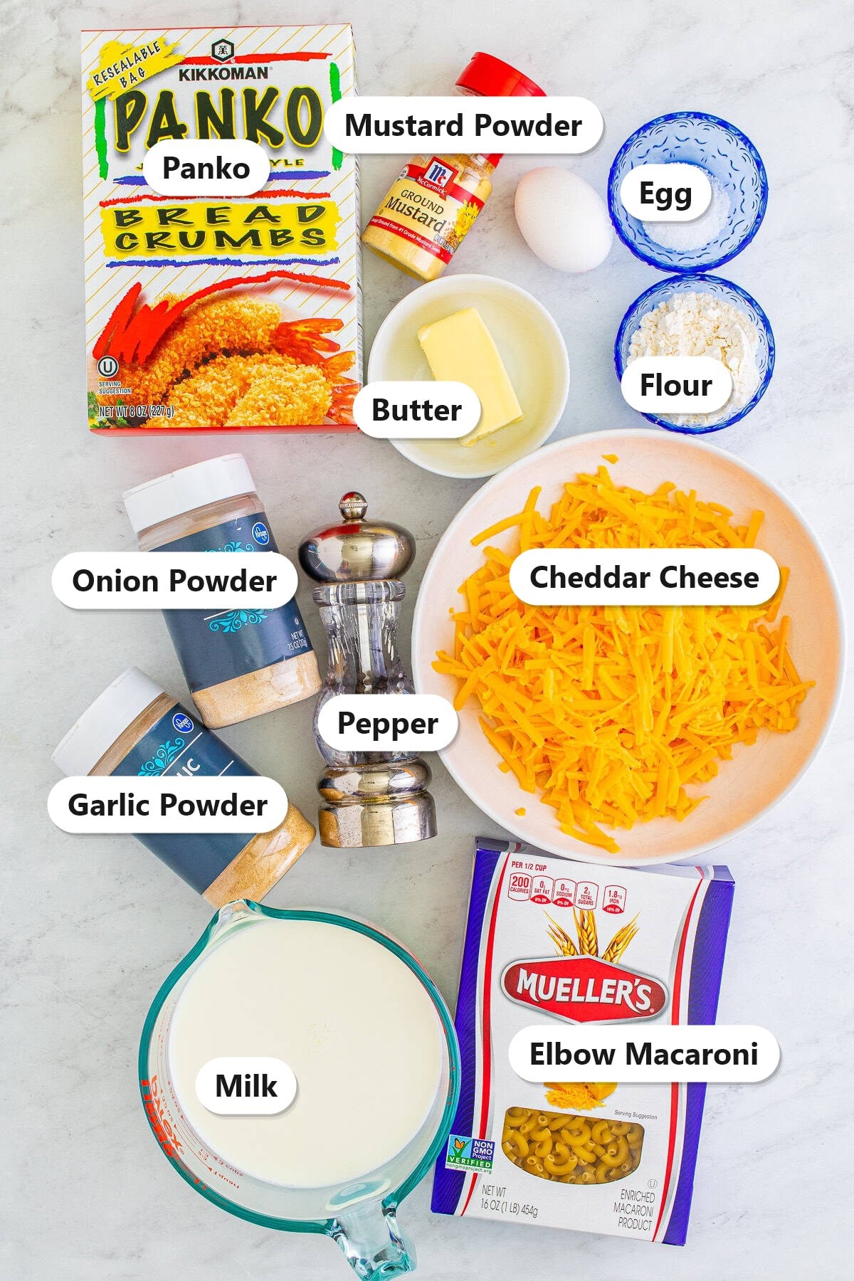 Labeled ingredients for fried mac and cheese including elbow macaroni, cheddar cheese, butter, flour, milk, egg, panko, and seasonings.