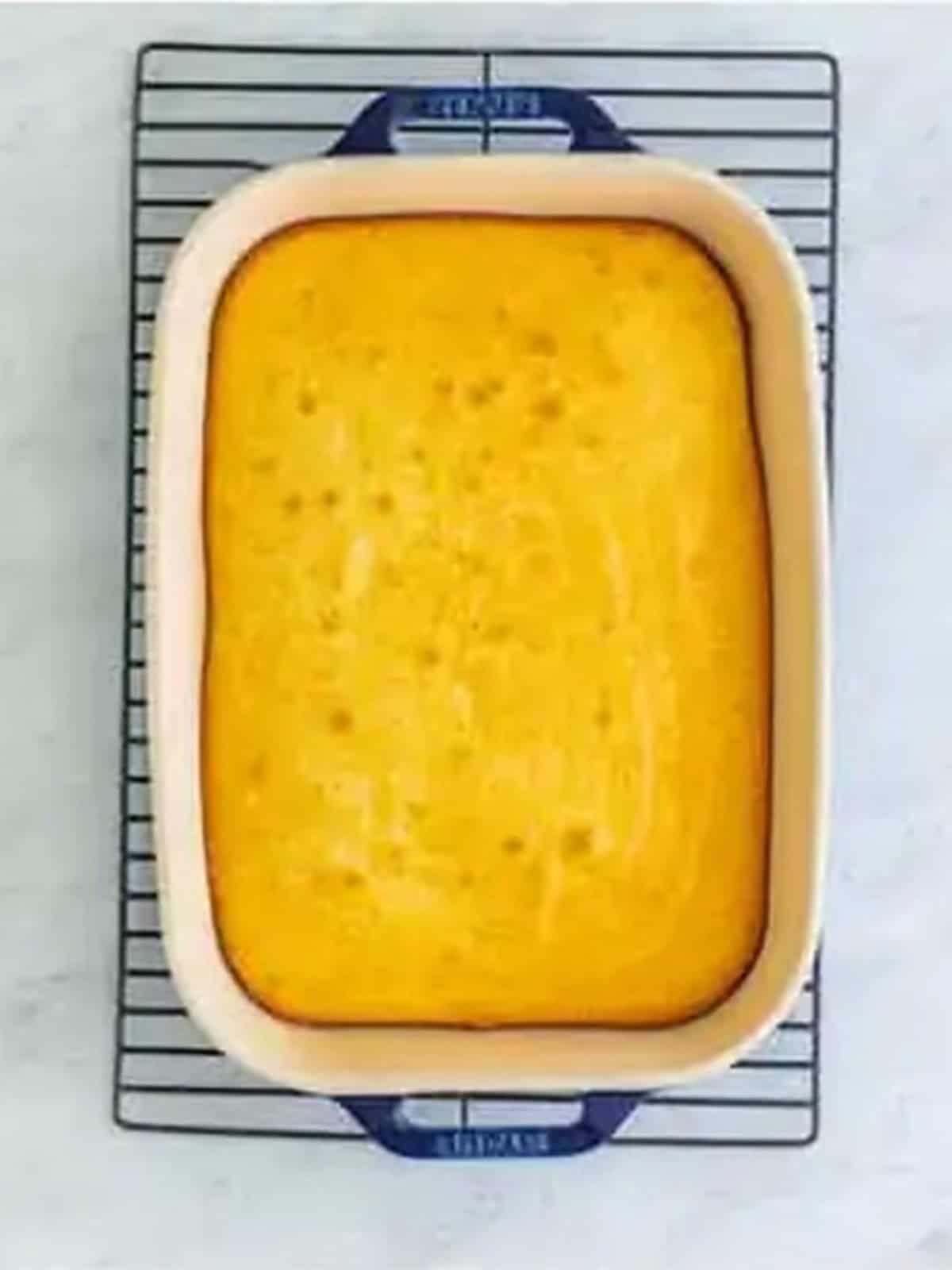 Baked white cake cooling on a rack for a 4th of July Trifle.