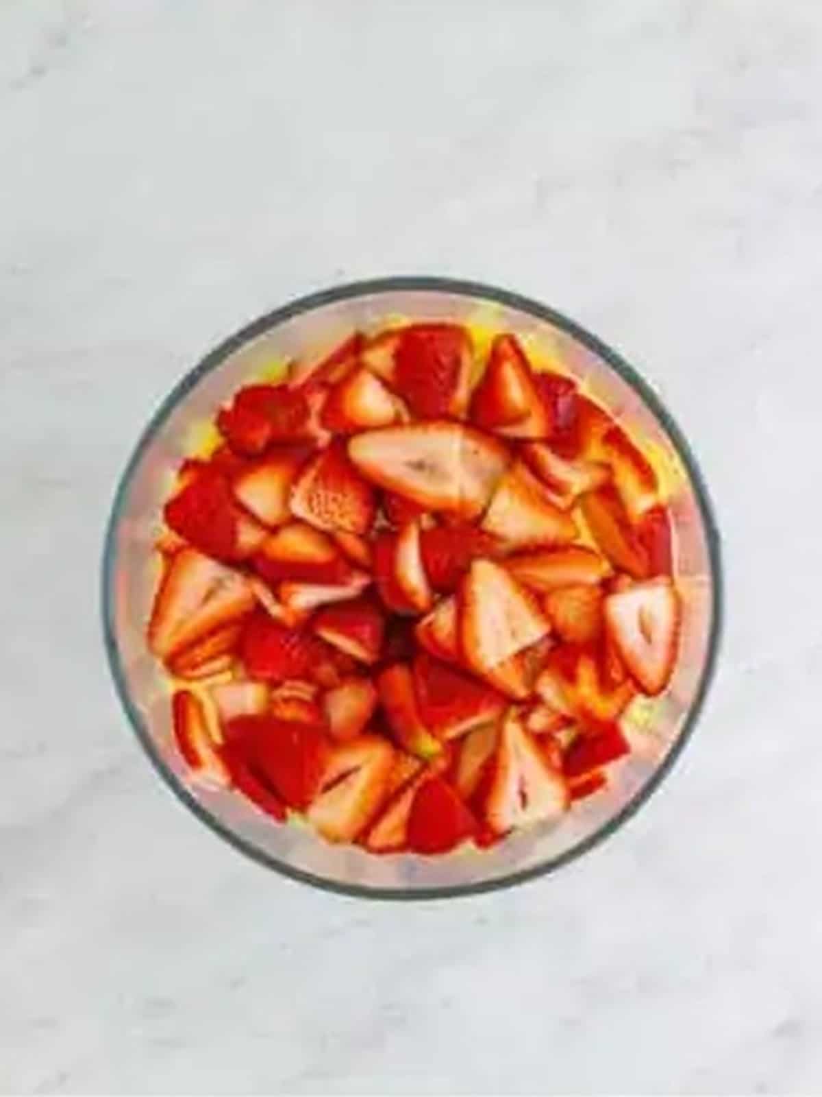 Sliced strawberries layered over pudding in a 4th of July Trifle.