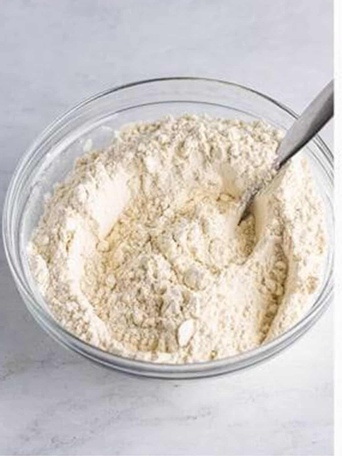 Flour, baking soda, and salt whisked together in a bowl for 7Up cake.