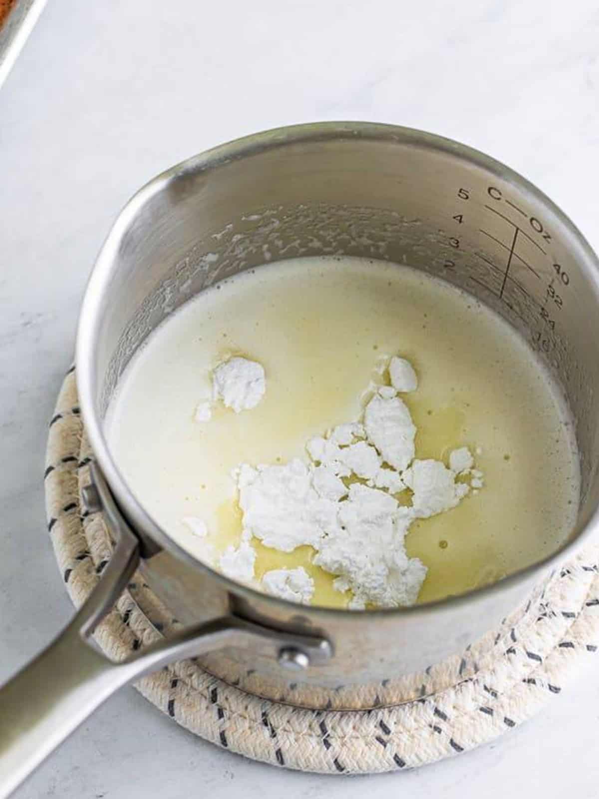 Butter, 7Up, and powdered sugar melting together in a saucepan for the 7Up cake glaze.