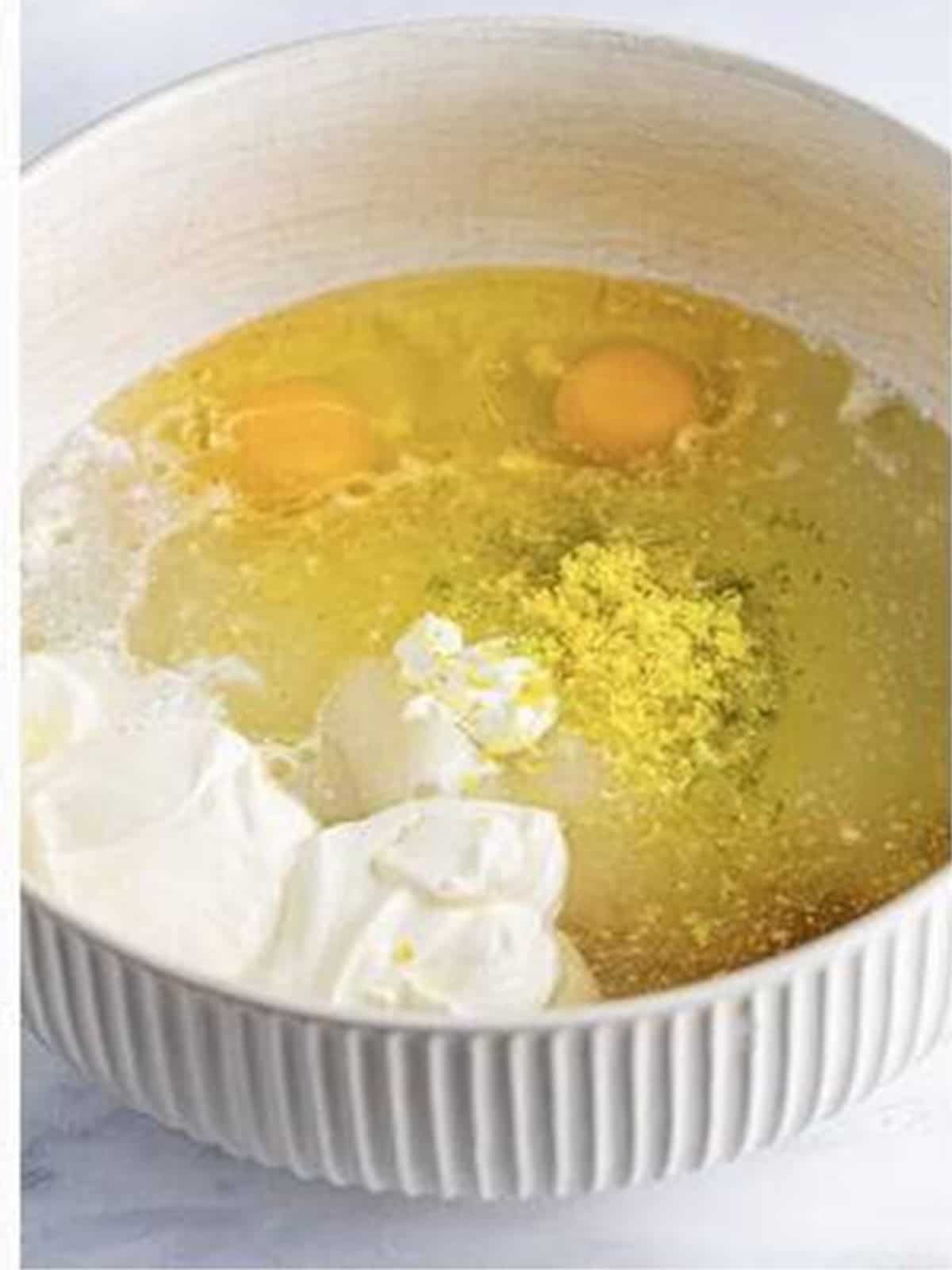 Sugar, 7Up, oil, sour cream, eggs, and citrus zest whisked together in a bowl.