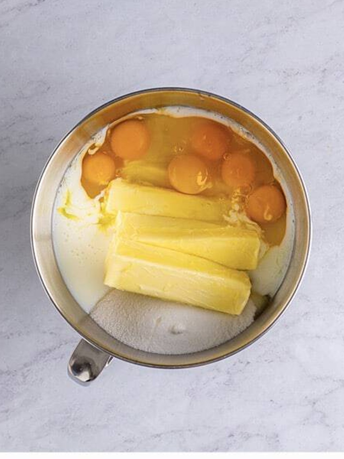 Flour, sugar, butter, eggs, buttermilk, and vanilla in a stand mixer bowl.