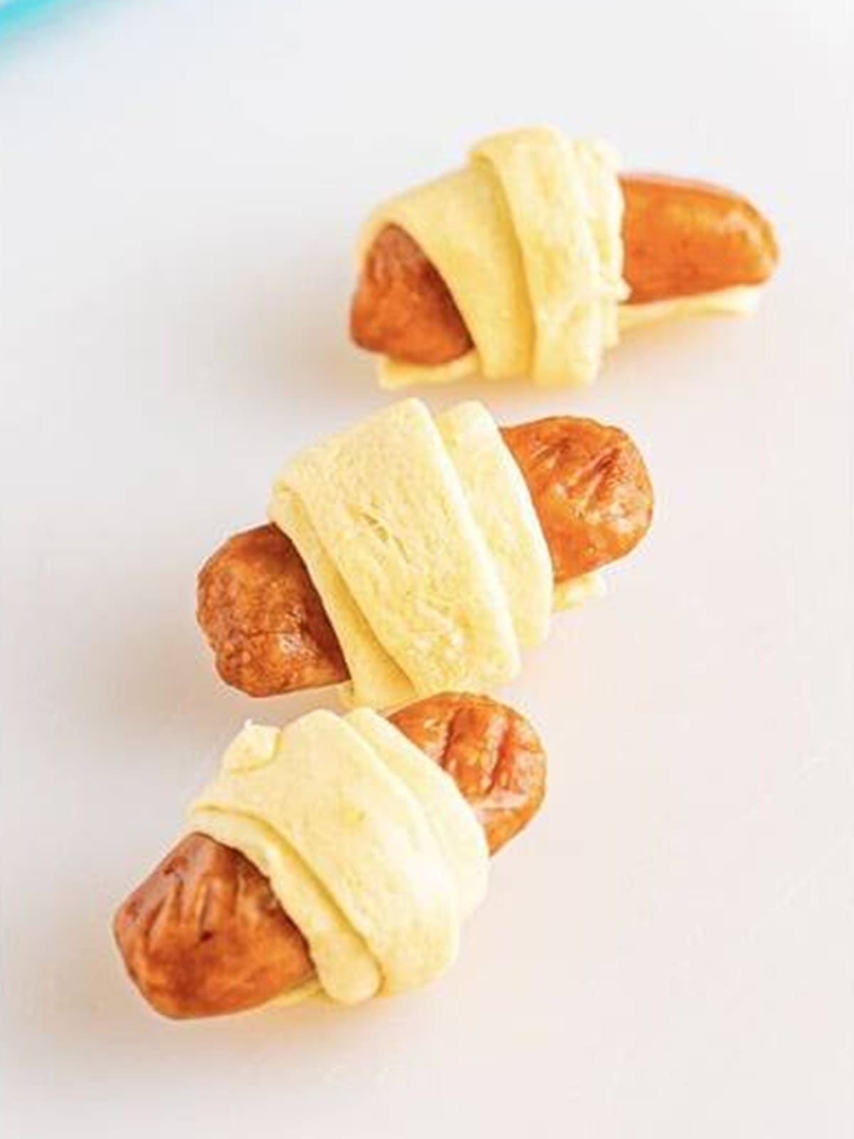 A lil smokie wrapped in a triangle of crescent dough.