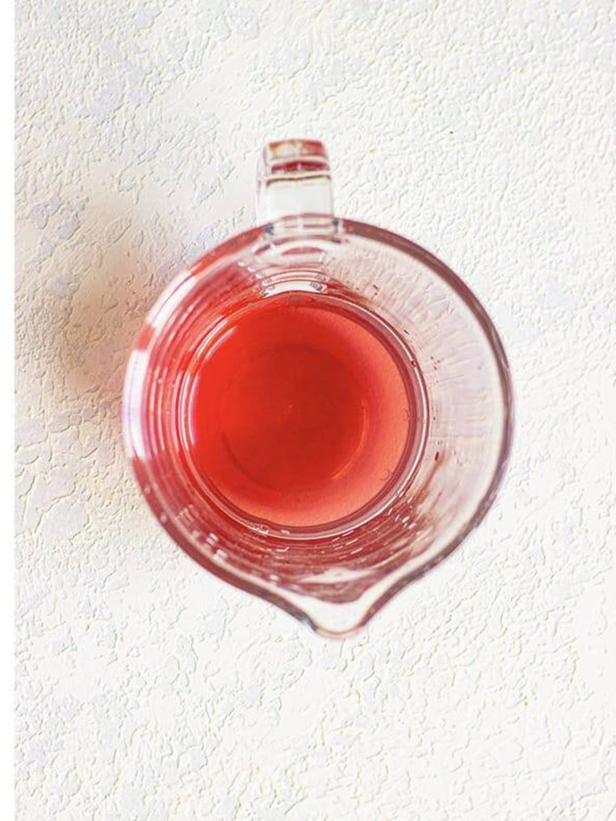 White grape juice mixed with chopped fresh strawberries in a glass bowl.