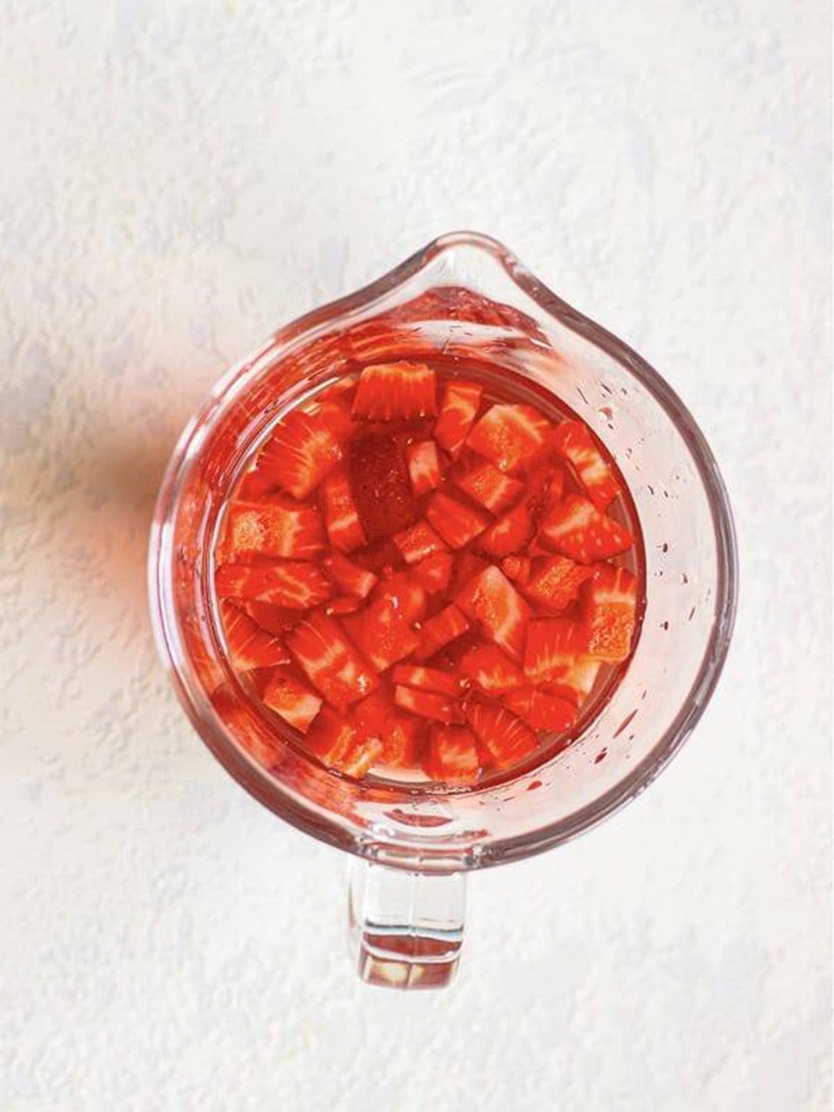 The powder mixture and strawberry grape juice combined into a red Strawberry Acai Refresher base.