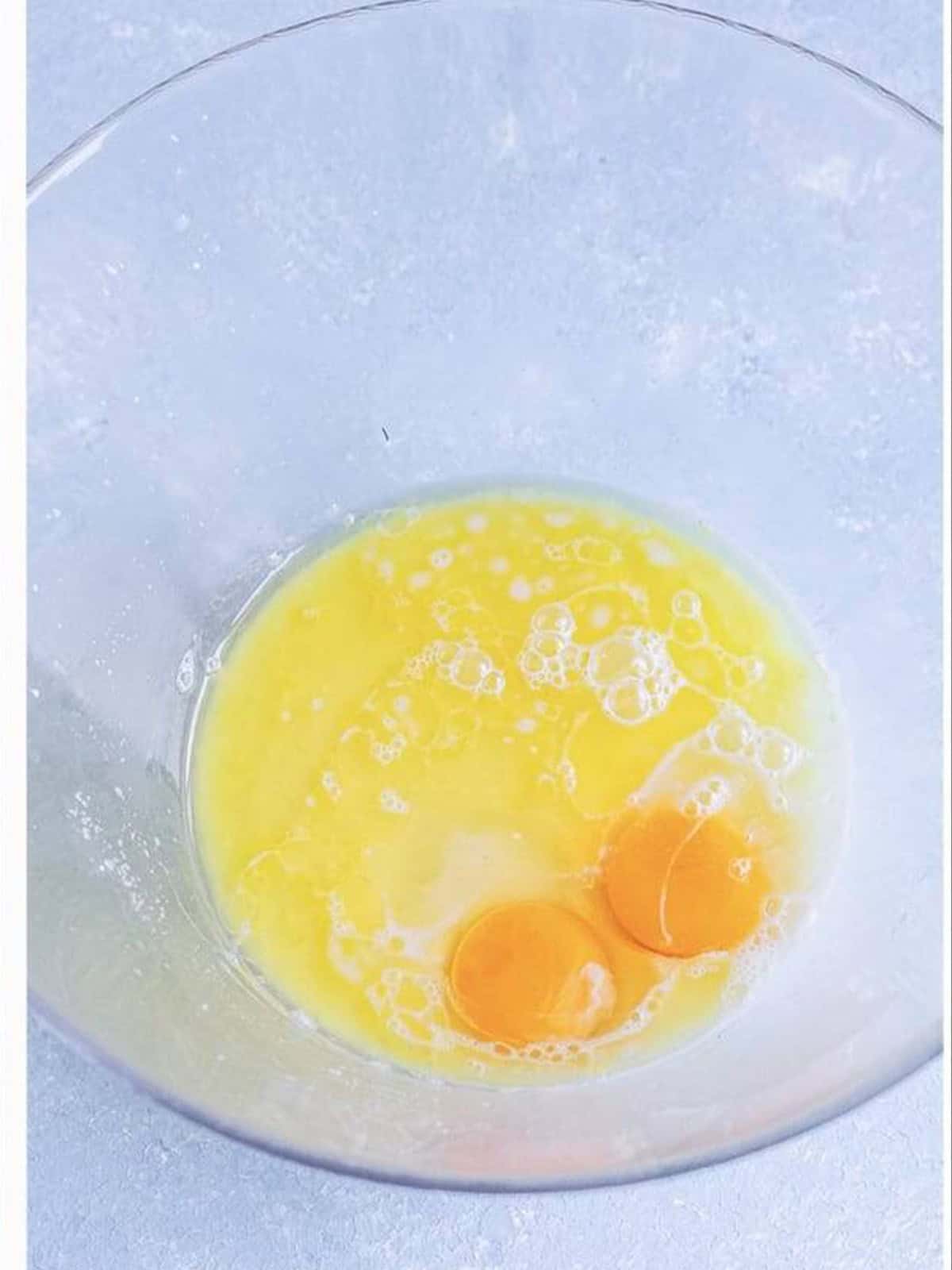 Eggs, melted butter, sugar, and salt added to the yeast mixture in a bowl.