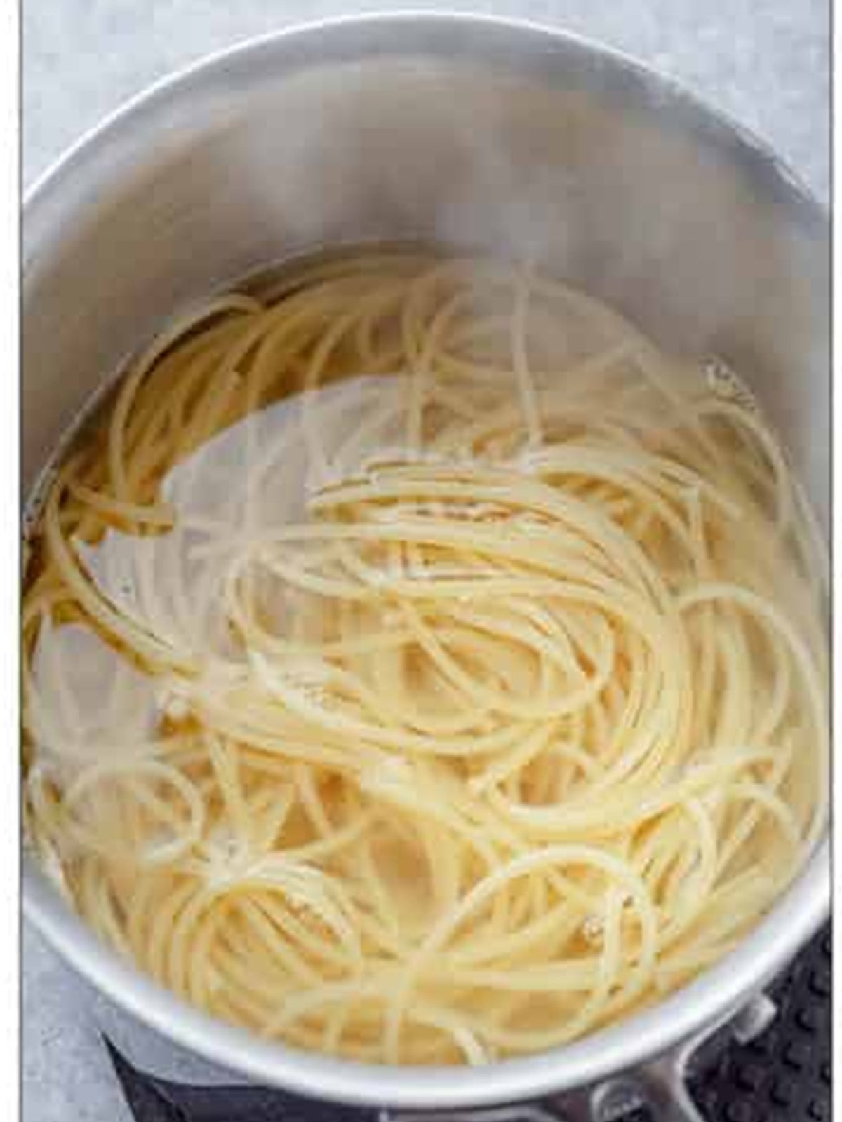 Cooking spaghetti in a pot of salted water for Aglio e Olio.