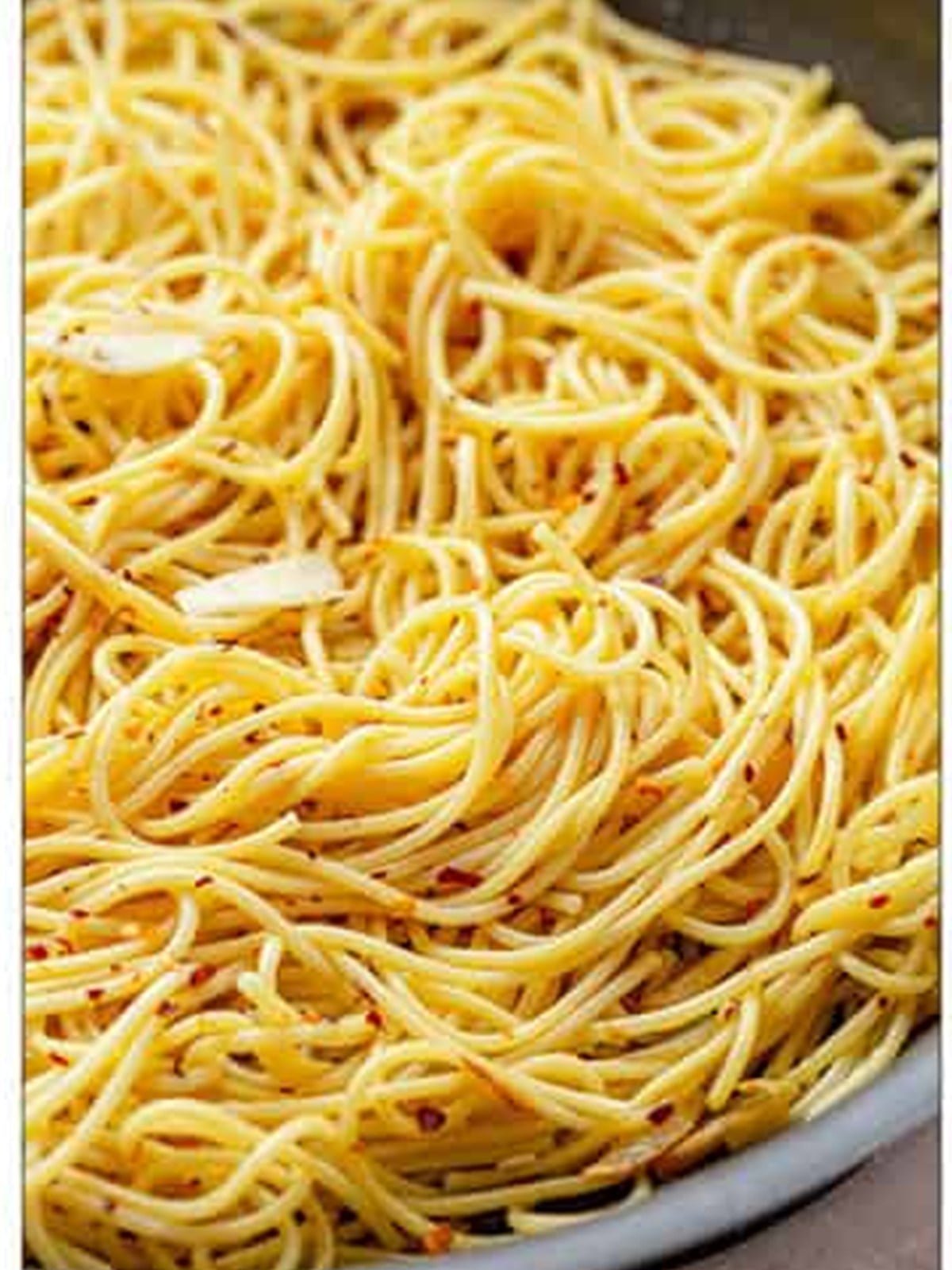 Mixing the spaghetti until evenly coated and glossy for Aglio e Olio.
