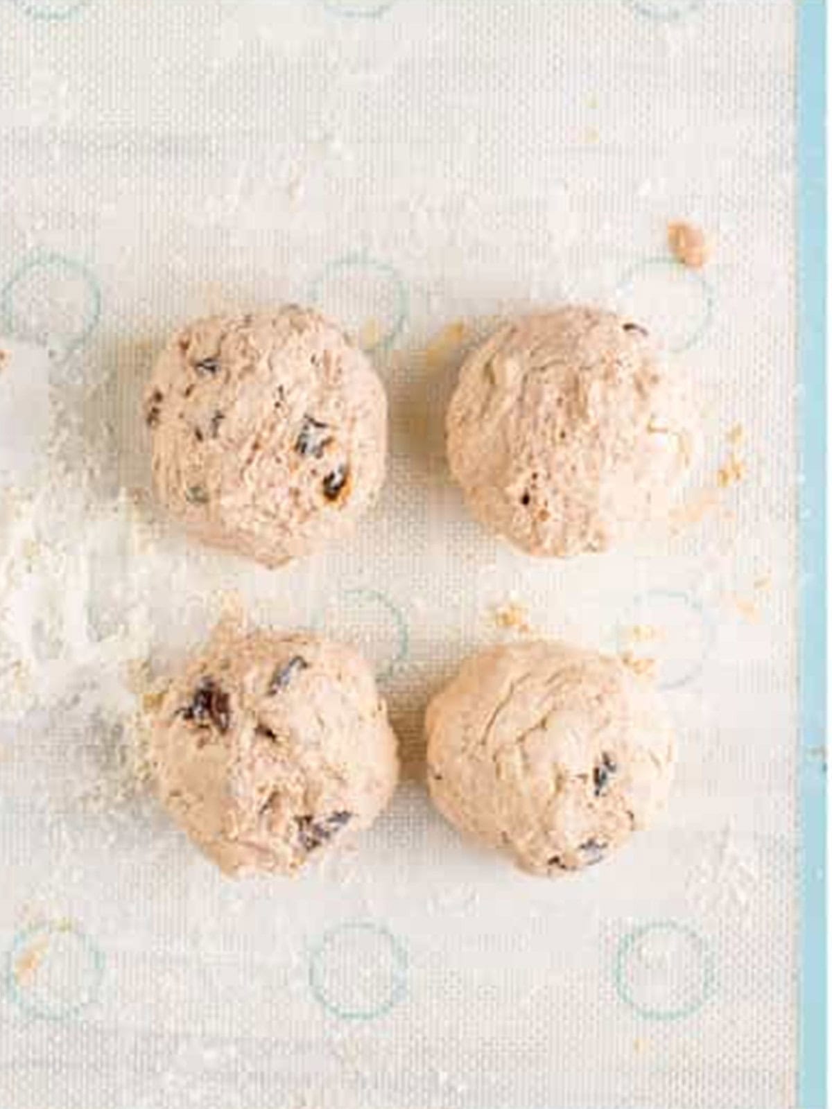 Bagel dough divided into four equal balls.