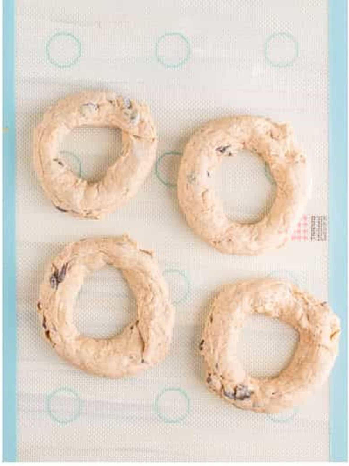 Bagel dough rolled into logs and shaped into circles before air frying.