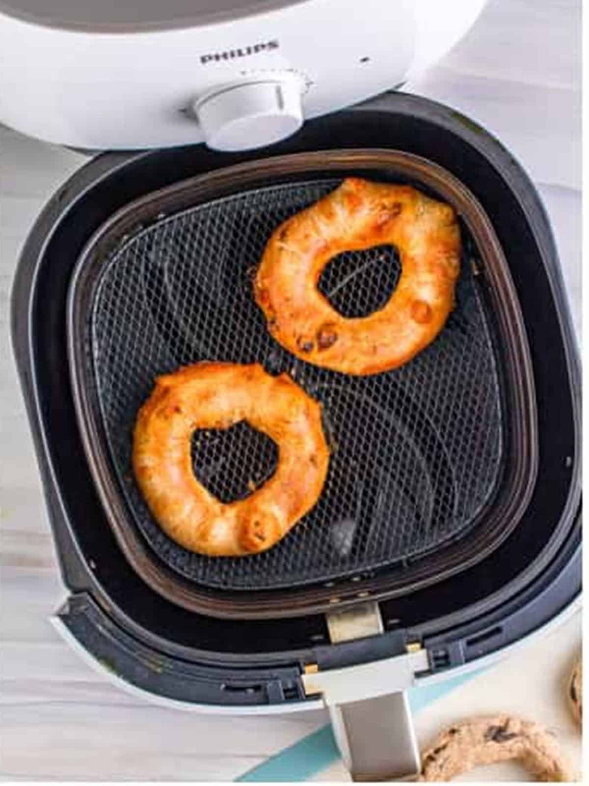 Golden brown cinnamon raisin bagels cooked in the air fryer.