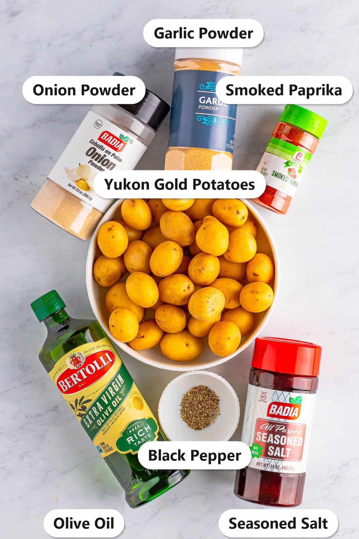 Labeled ingredients for air fryer home fries including baby Yukon gold potatoes, olive oil, seasoned salt, smoked paprika, garlic powder, onion powder, and black pepper.