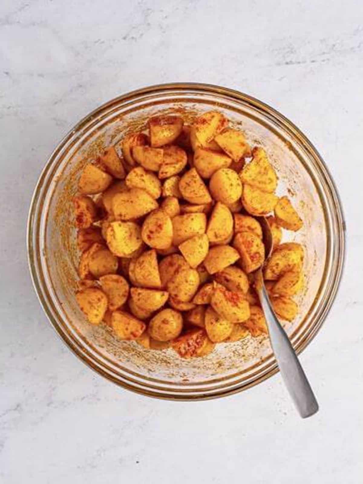 Potatoes tossed with olive oil and seasonings for air fryer home fries.