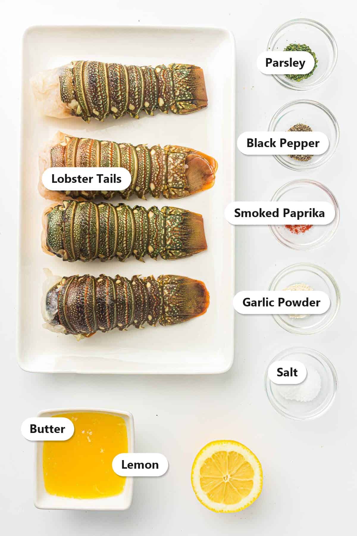 Labeled ingredients for air fryer lobster tails including lobster tails, butter, lemon, parsley, garlic powder, smoked paprika, salt, and black pepper.