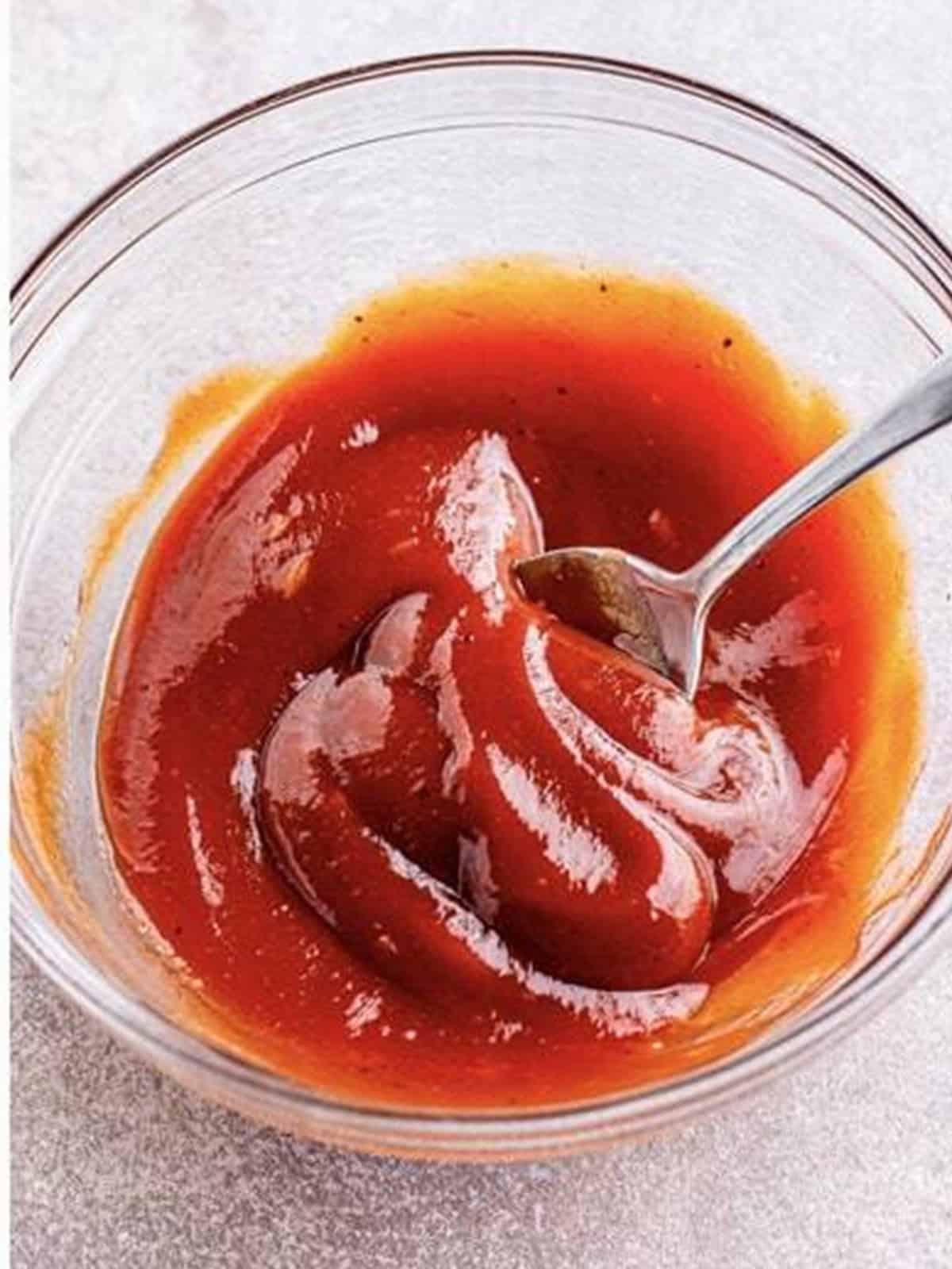 Ketchup and BBQ sauce glaze mixed in a small bowl for air fryer meatloaf.