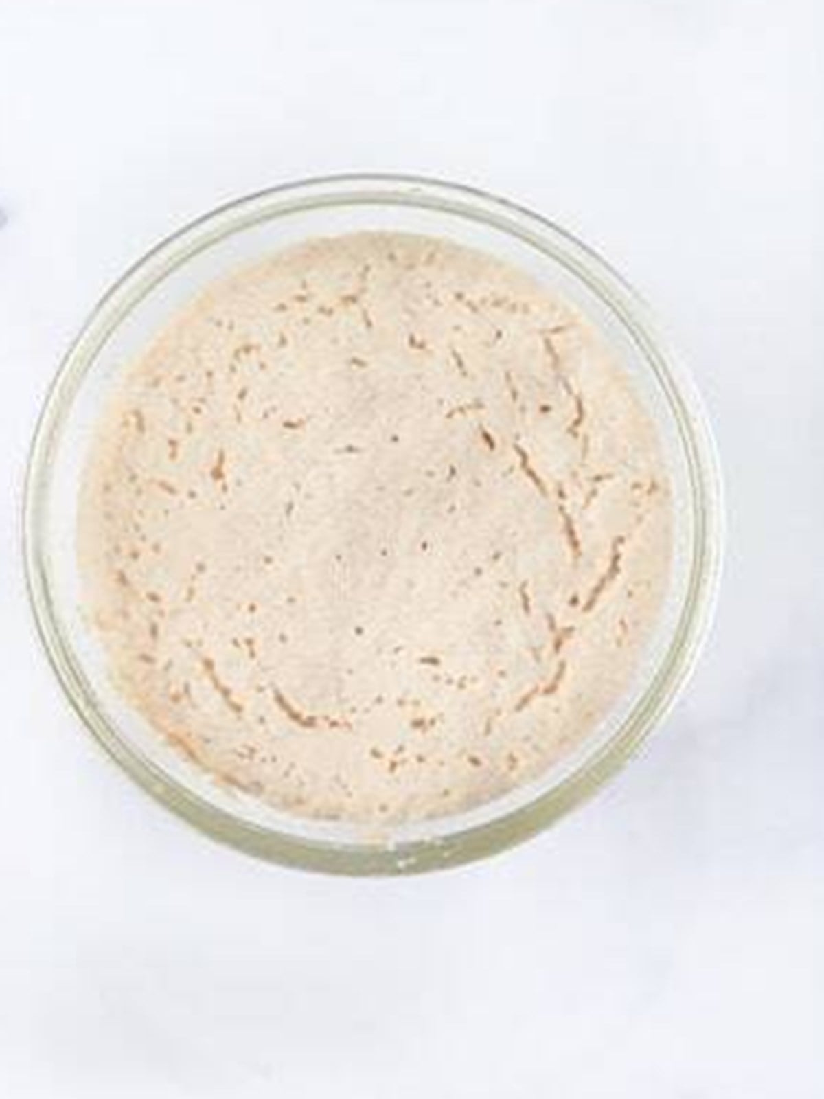 Frothy activated yeast in a bowl for air fryer naan bread dough.