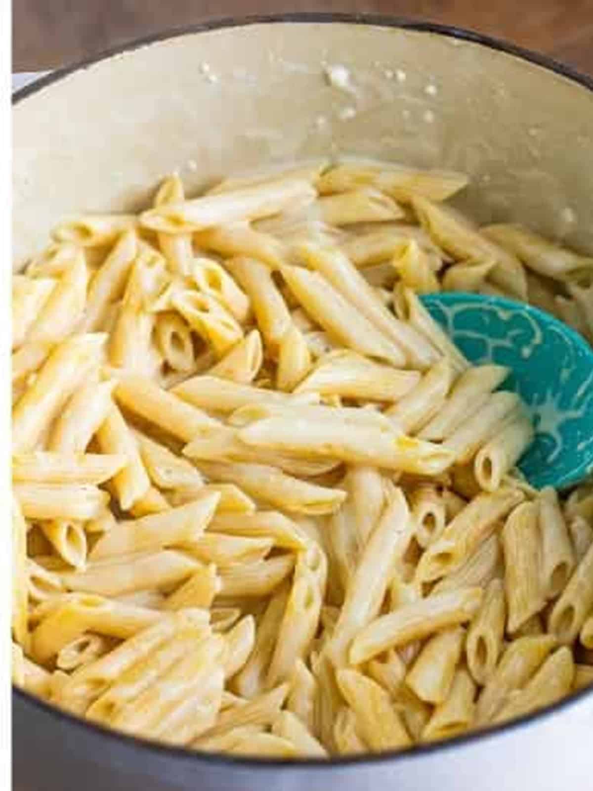 Penne stirred into the alfredo sauce until creamy and fully coated.