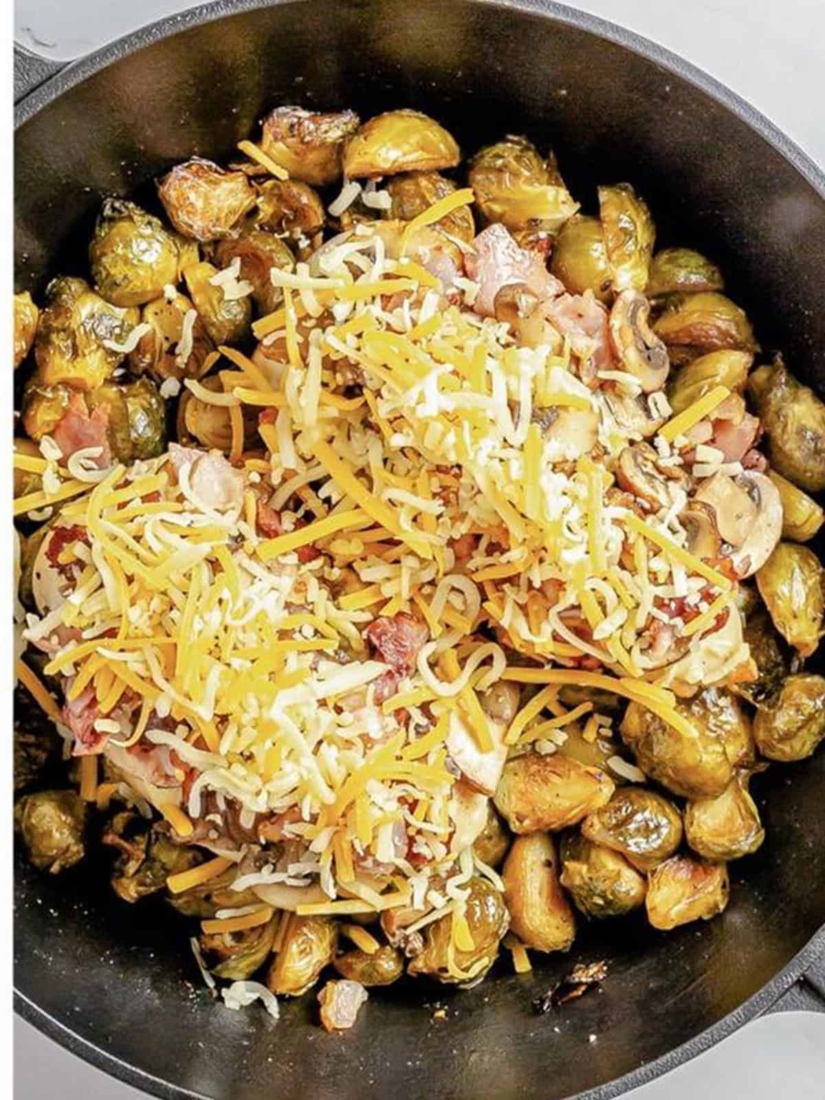 Shredded colby jack cheese added on top of Alice Springs chicken before melting.