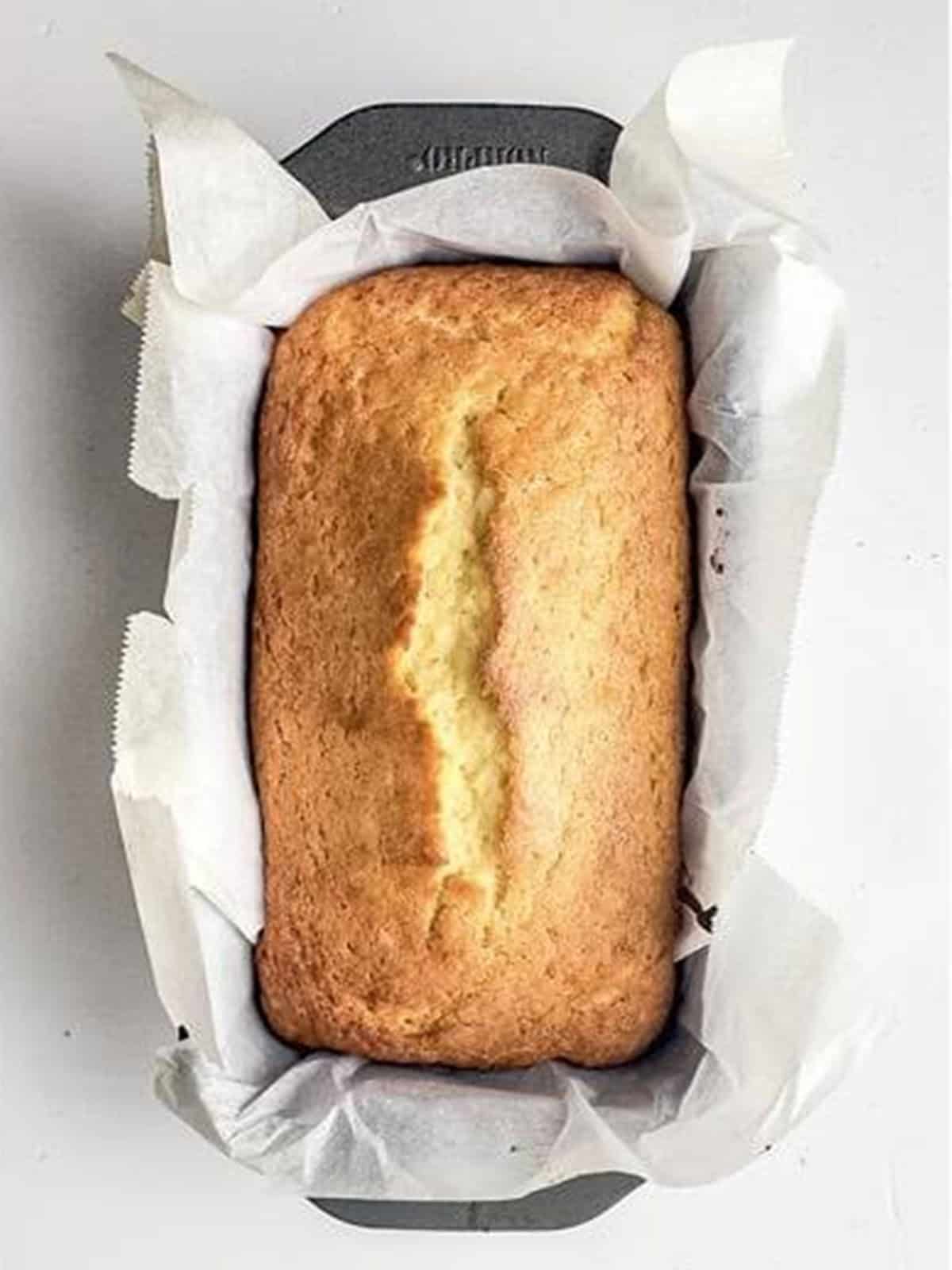 Golden baked almond loaf cake in the pan.