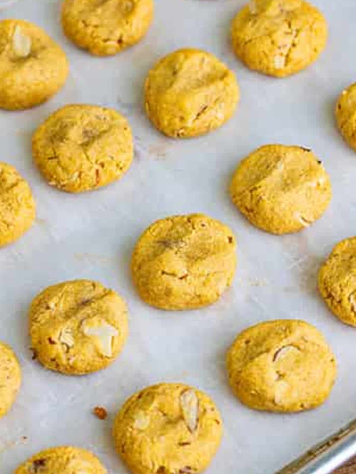 Baked almond flour cookies on a baking sheet.
