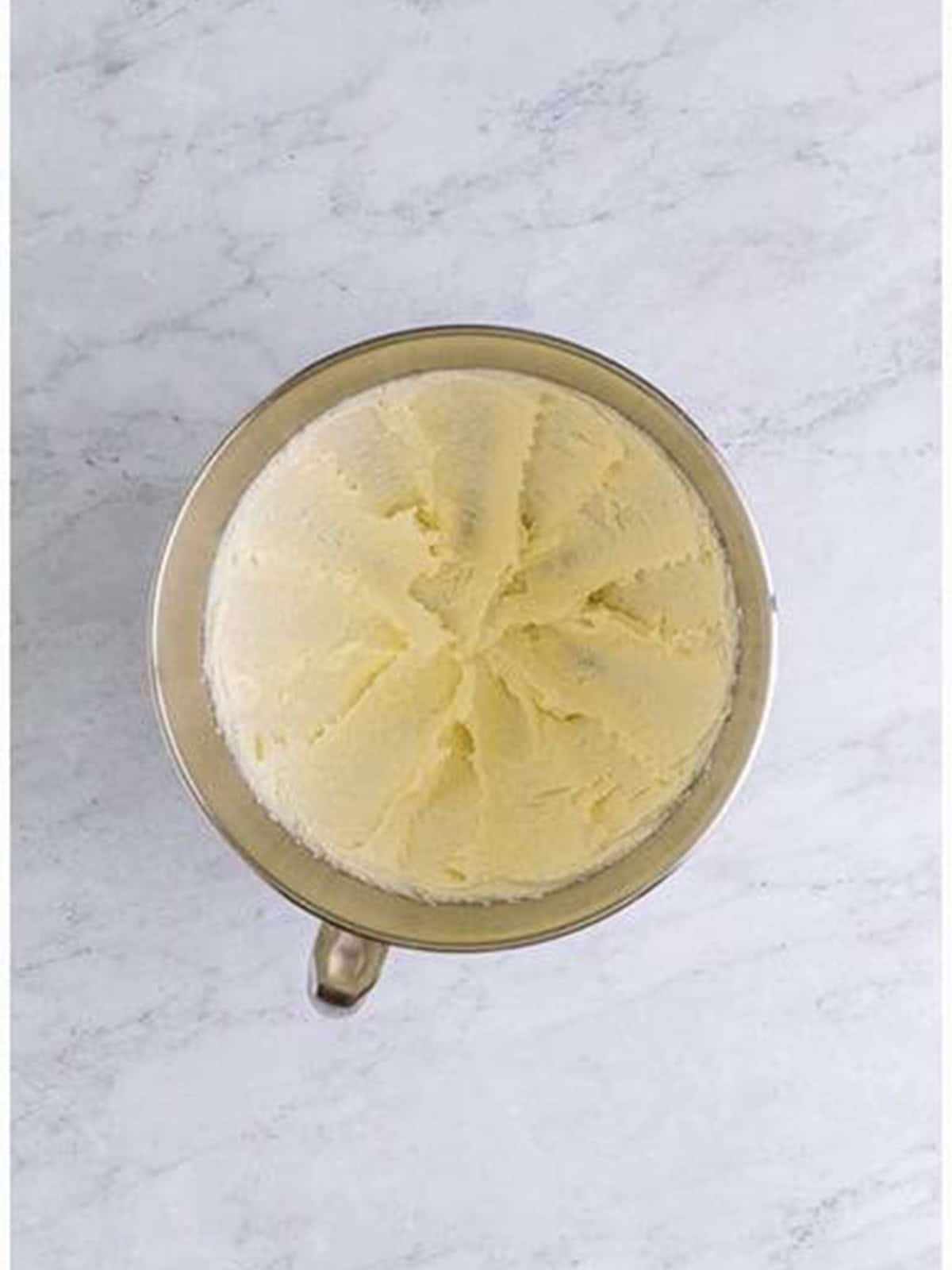 Creamy almond cake batter mixed in a stand mixer bowl for almond torte cake.