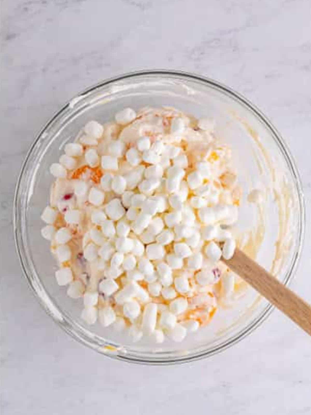 Mini marshmallows folded into ambrosia salad.