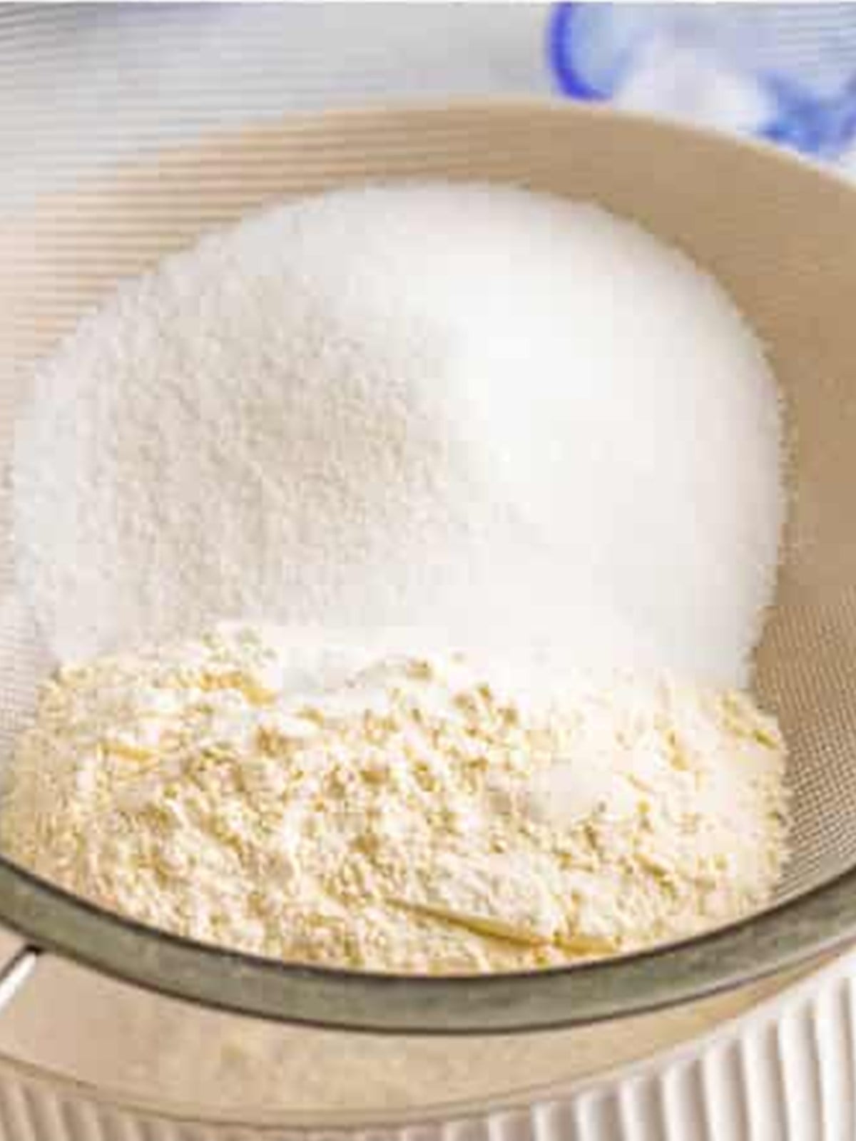 Flour, sugar, and salt sifted together in a glass bowl for angel food cake.