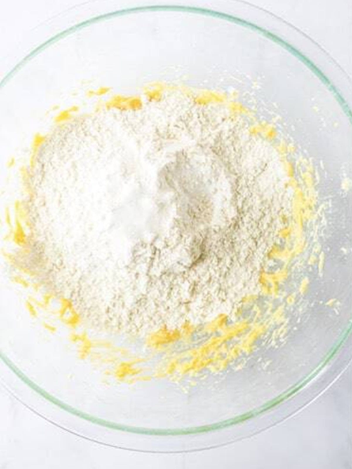 Flour added to the creamed butter and sugar for animal cracker cookies.