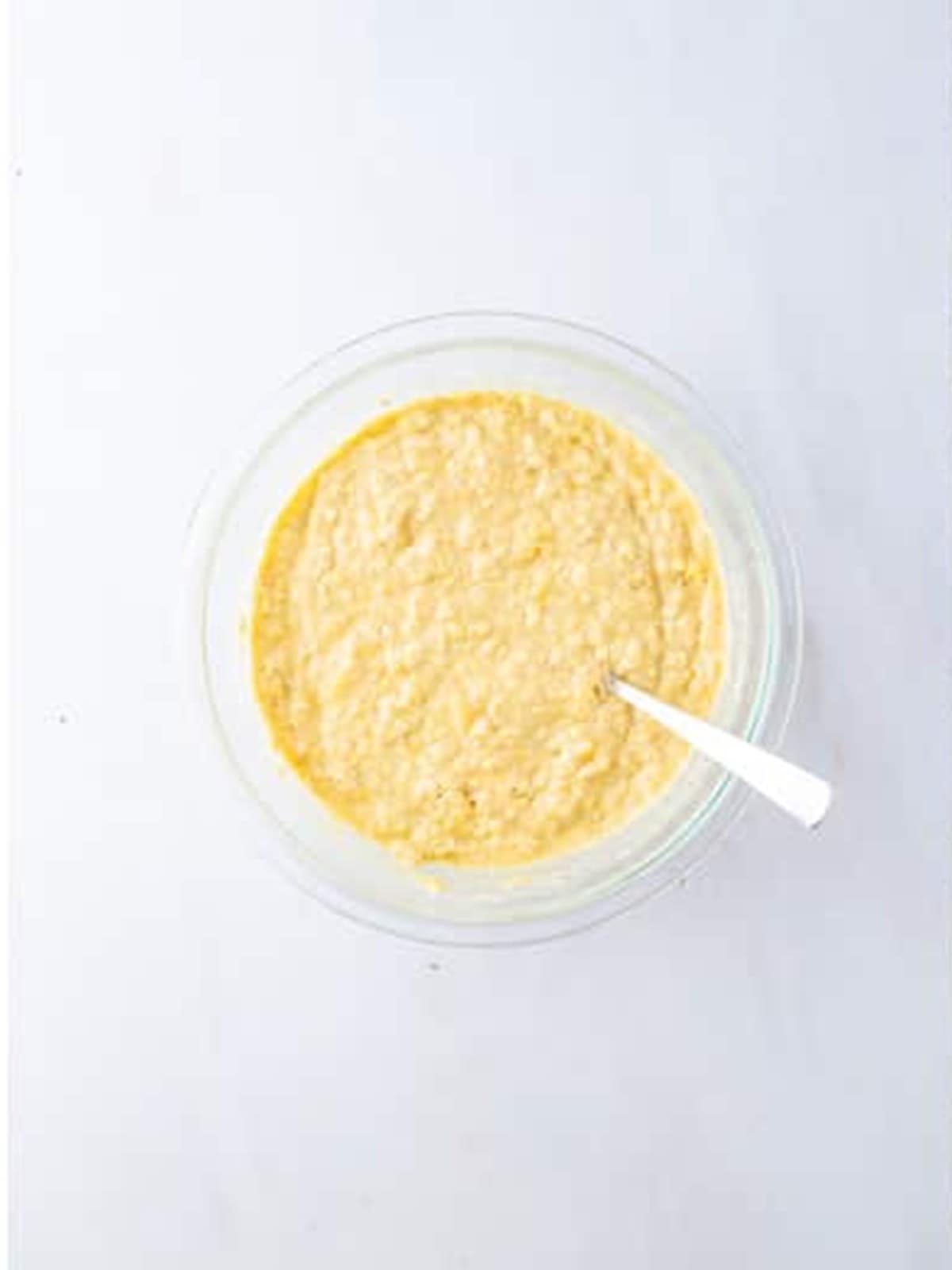 Dry ingredients folded into the wet mixture until just combined for apple banana muffins.