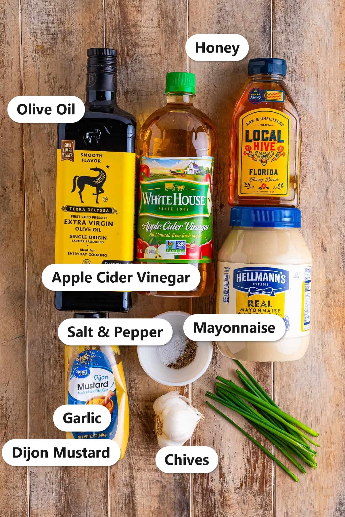Apple cider vinegar dressing ingredients labeled including olive oil, apple cider vinegar, honey, mayonnaise, dijon mustard, garlic, and chives.