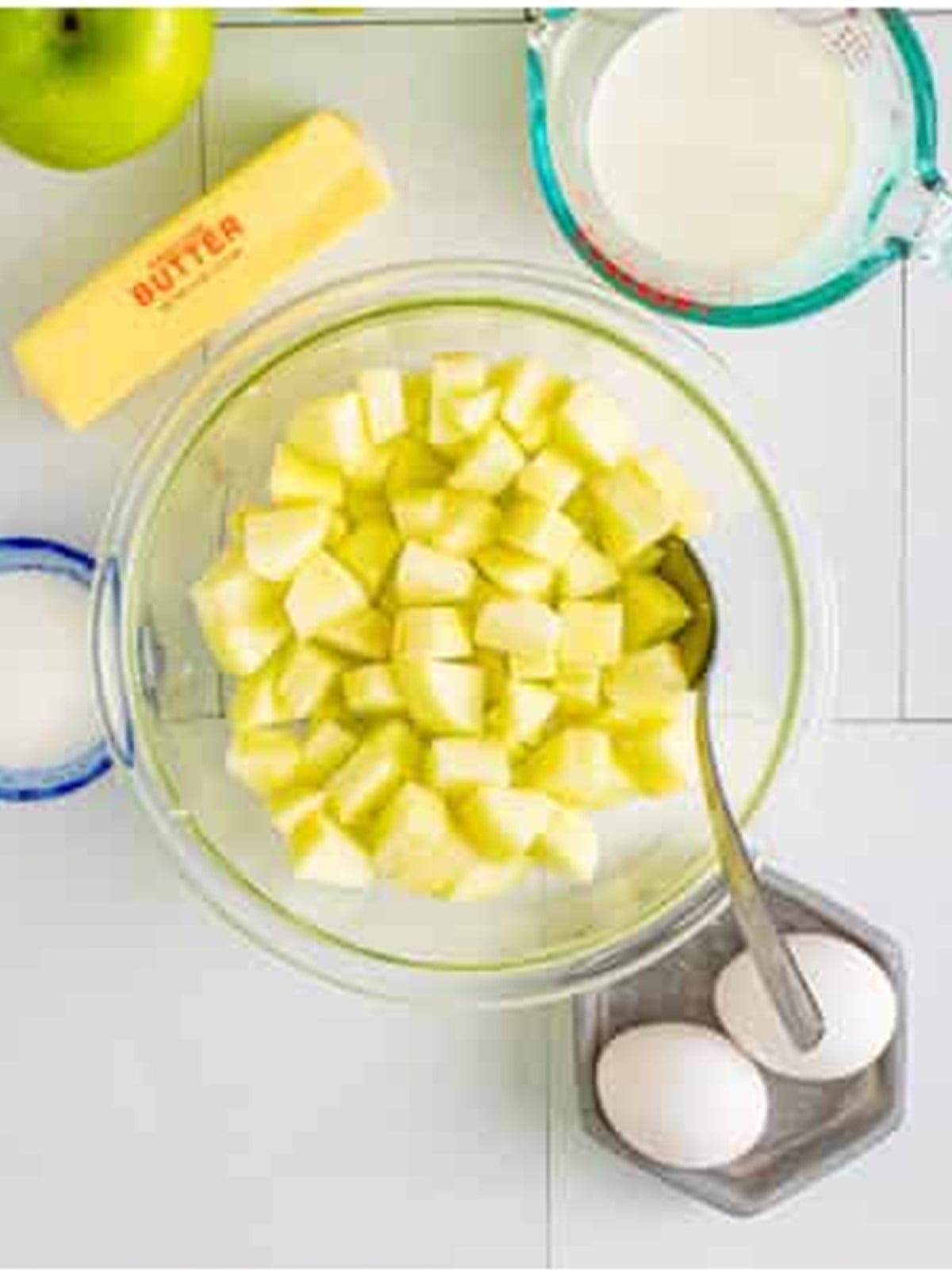 Diced Granny Smith apples tossed with lemon juice for apple fritters.