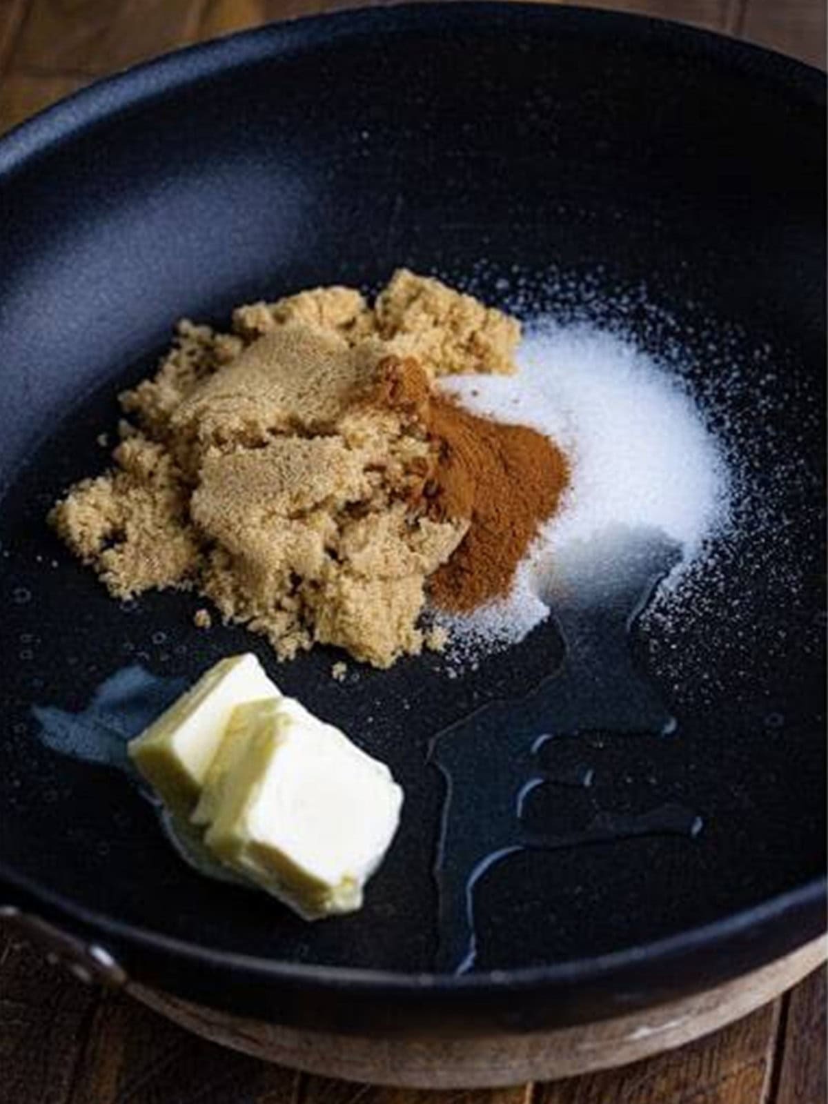 Melting butter with brown sugar and cinnamon in a skillet.