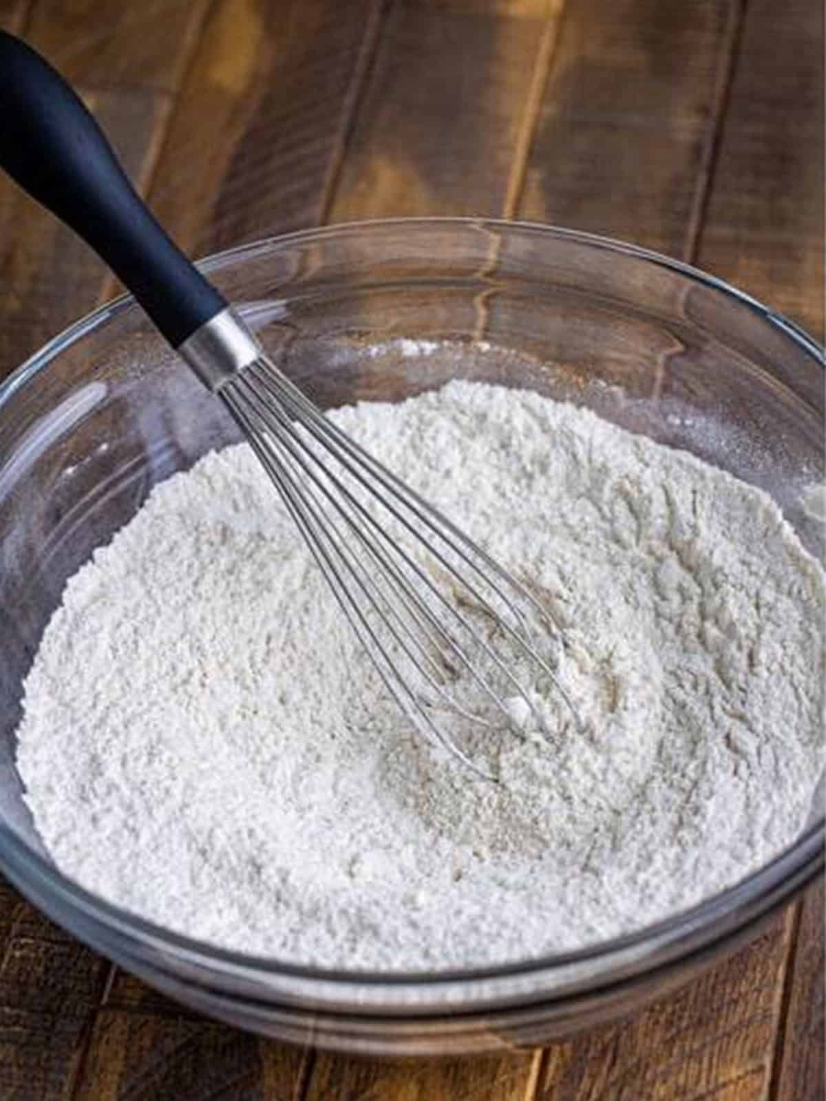 Whisking together the dry pancake ingredients in a bowl.
