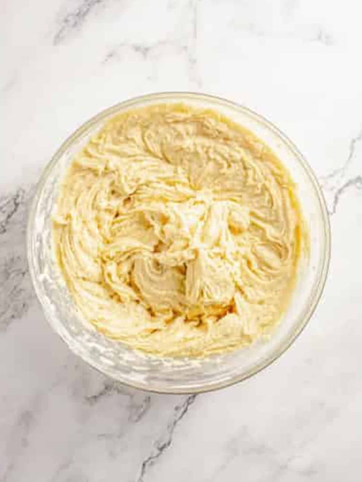 Apple pie bars batter mixed with flour in a glass bowl.