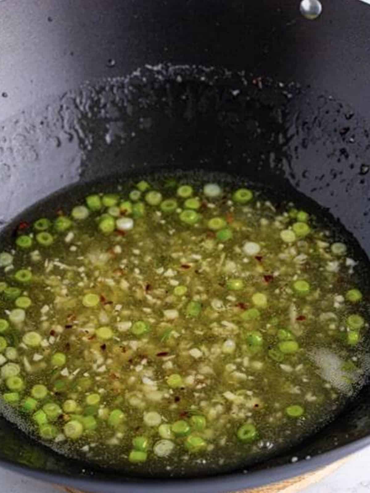 Glossy thickened asian lemon sauce in the wok.