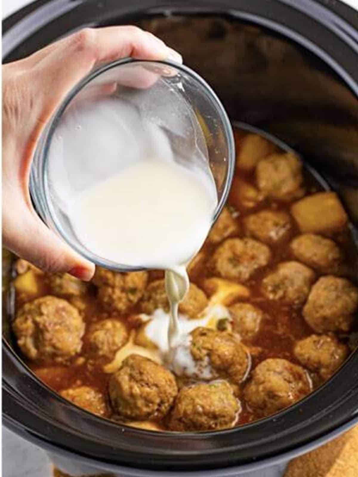 A cornstarch slurry poured into the slow cooker to thicken the sauce.