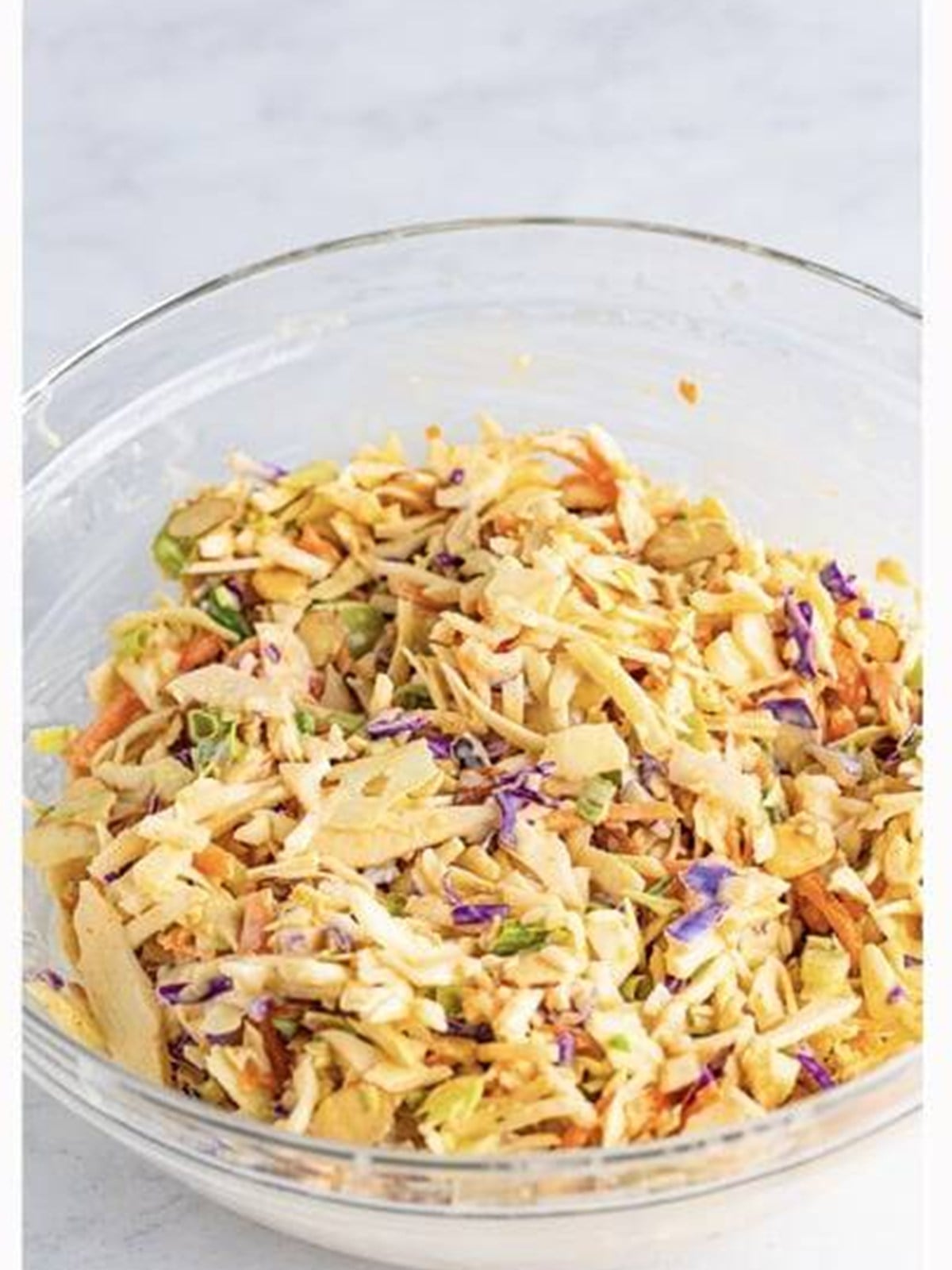 Asian slaw tossed and coated in creamy dressing.