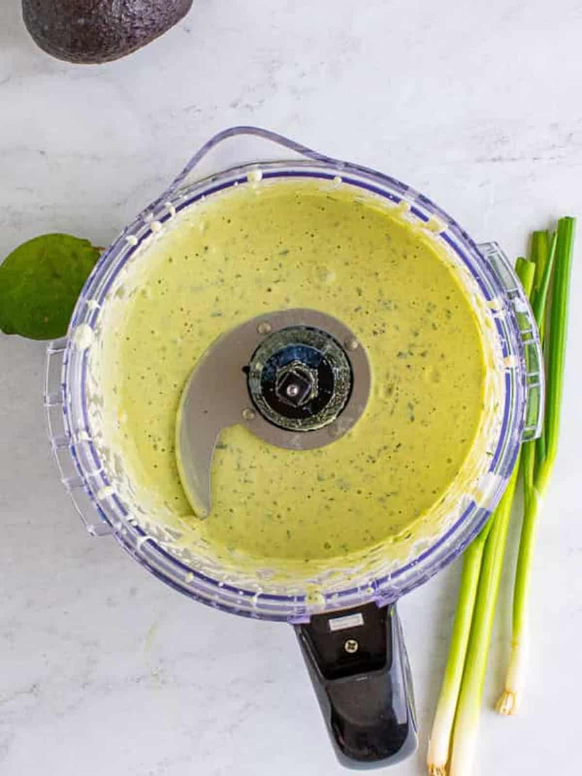 Smooth, creamy green avocado ranch blended in a food processor.