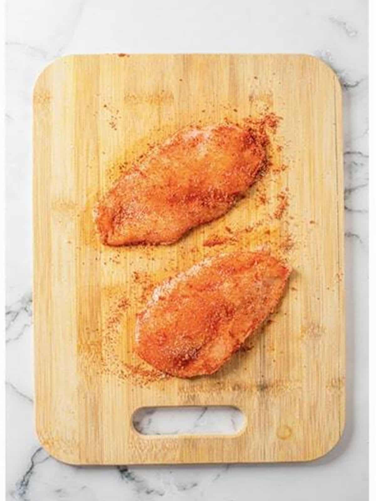 Chicken breasts seasoned with smoked paprika, onion powder, salt, and pepper.